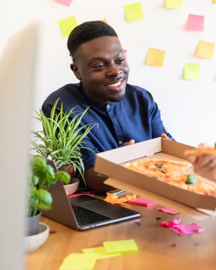 Happy staff sharing a pizza