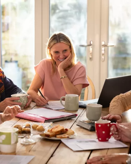 Group of care home managers in meeting smiling