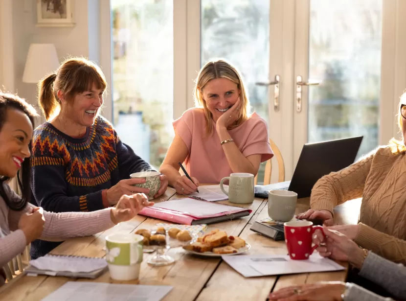 Group of care home managers in meeting smiling